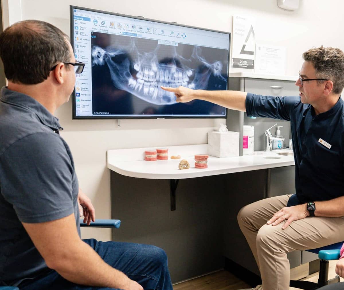 doctor showing patient orthodontic scans